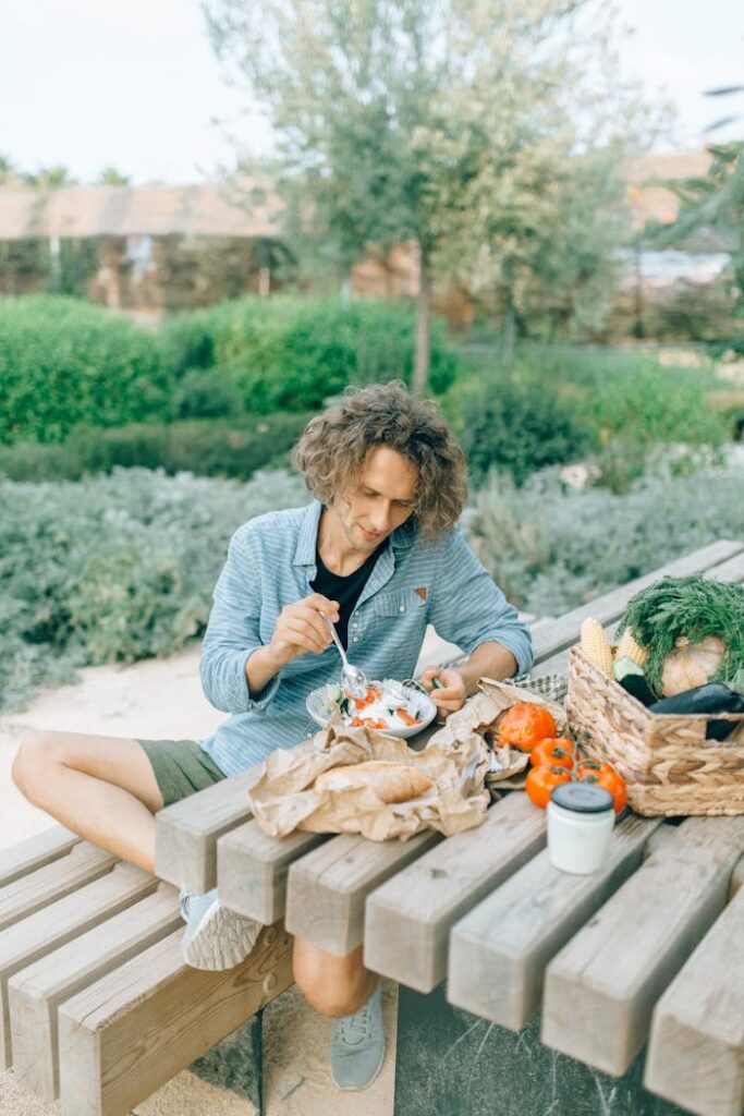 Man in Gray shirt  Sitting on Brown Wooden Bench